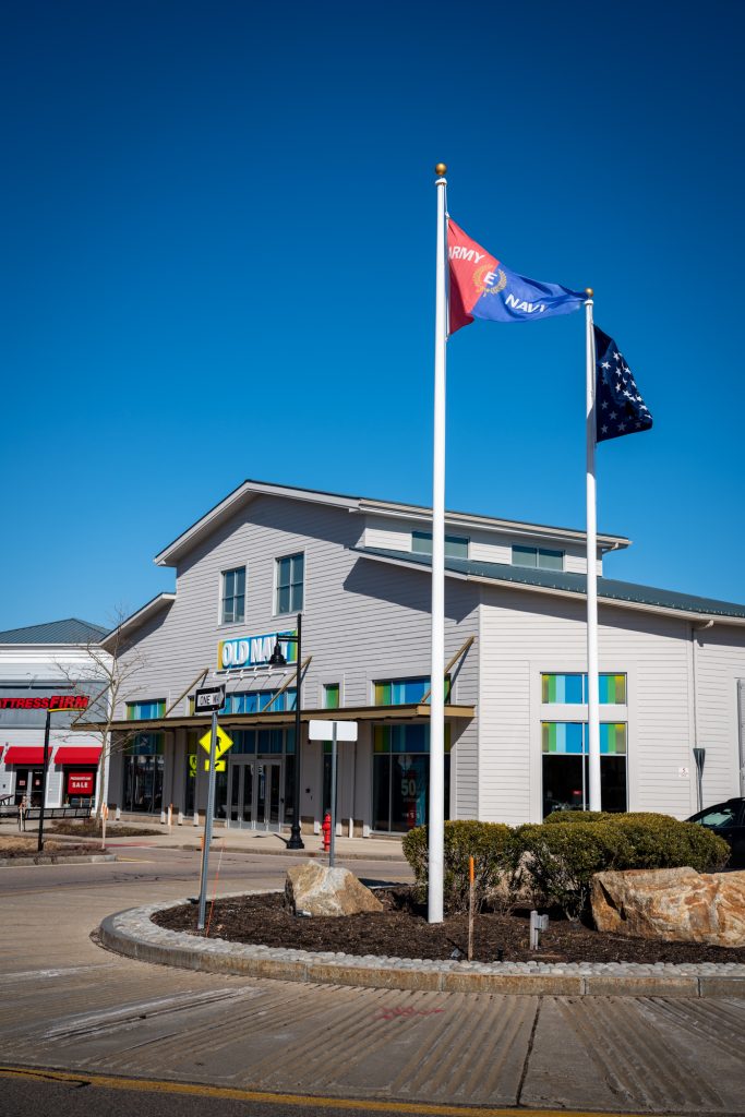 Zeus Flagpoles Aeolus Series in front of a commercial building